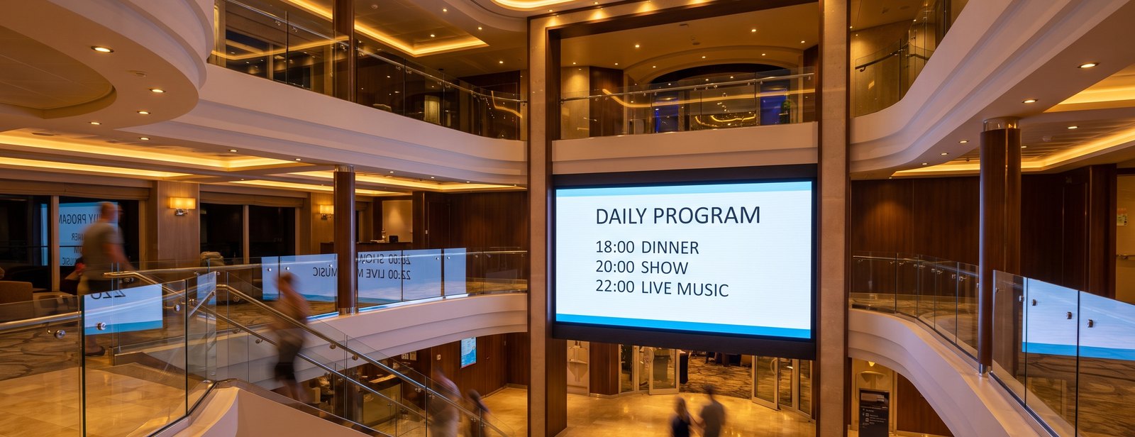 A large lit screen showing the daily programme in a cruise ship atrium